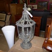 A verdigris candle lantern with five tea