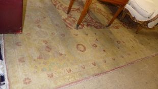 An Agra design carpet the terracotta ground with floral decoration