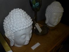 A pair of white painted Buddha heads