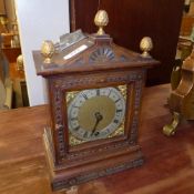 A C20th mantle clock with Roman numeral dial and acorn finial