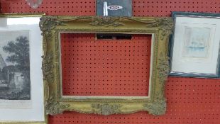 A pair of carved swept giltwood frames
