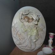 A pair of Dresden style wall plaques of children at play