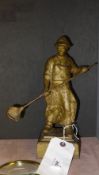 A heavy gilt cast-iron figure of a metal