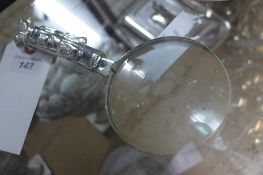 A silver plated magnifying glass with golf bag handle
