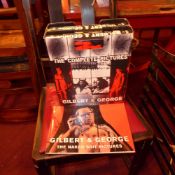 Two boxed volumes of pictures of Gilbert and George together with a signed colour catalogue