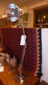 An industrial polished steel anglepoise lamp