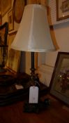 A painted figure form table lamp with white shade