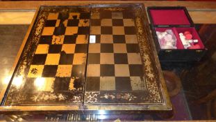 A Chinoiserie chess board and bone chess set
