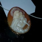 A Victorian 9ct gold cameo brooch depicting a saint carrying a child