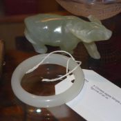 A Chinese agate bangle and a similar carved figurine of an ox