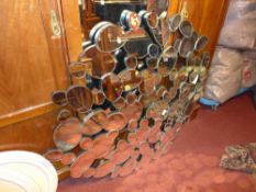 A contemporary designer pebble style wall mirror with multiple bevelled plates