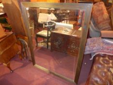 An oak framed wall mirror with bevelled plate