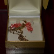 A 9ct gold ankle chain with a peanut charm together with a pair of coral earrings