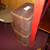 A brown travelling trunk with wooden bracing