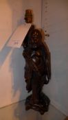 A pair of Chinese carved hardwood table lamps in the form of a fisherman and another