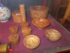 A collection of burr walnut items, including bowls, a pestle and mortar and lidded box