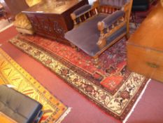 A fine North West Persian Heriz carpet 350 x 170cm, central pole floral medallion on a terracotta