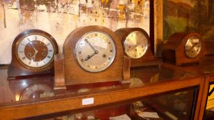A collection of four 1930's oak mantel clocks, including one by Smiths and another by Everite
