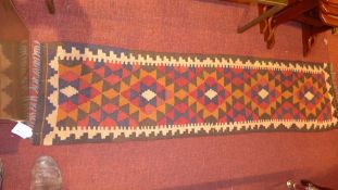 A Persian hand knotted Kelim runner with geometric decoration