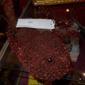 A small bag made from many seeds