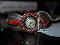 A Native American sterling silver and coral watch bracelet with an inset lyceum watch