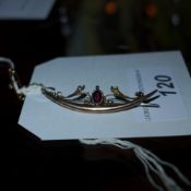 A 9ct gold ladies brooch inset with garnet stone and seed pearls
