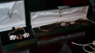 A matching 9ct gold plated necklace and bracelet decorated with elephants, purchased from Fior in