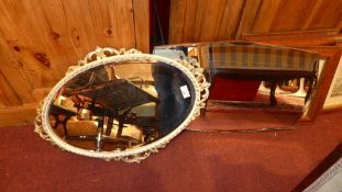 A 1950's frameless wall mirror together with a parcel gilt roccoco wall mirror