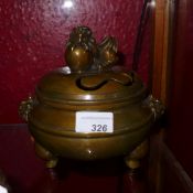 A Chinese bronze incense burner with pierced detail and Kylin surmount