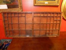 A wooden hanging wall rack with multiple divisions