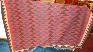 A Persian hand knotted Kelim rug with red field
