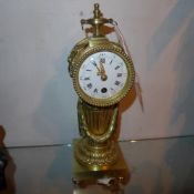 A C19th French brass clock with Roman numerals to the dial and an 8 day movement
