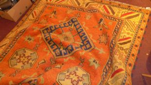 A hand knotted Kazak carpet with red field and repeating motifs in multi border
