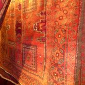 A fine North East Persian Turkoman carpet 282 x 172cm, repeating stylized Kazak motifs on a rouge