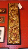 An Oriental carved giltwood panel with extensive and intricate battle scenes in relief together with