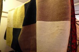 A contemporary rug having beige and black chequered design