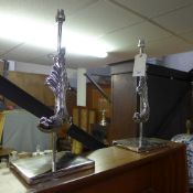 A pair of chromium Fleur de Lys relief table lamps