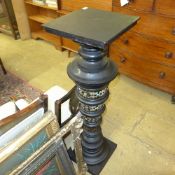 An ebonised and porcelain column