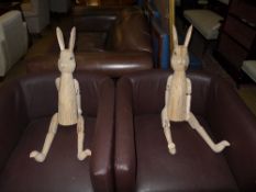 A pair of articulated wooden hares