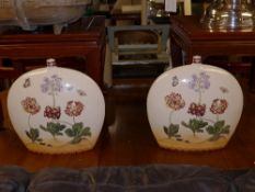 A pair of moon flask vases with floral and butterfly decoration