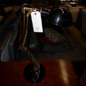 An ebonised and brass angle poise desk lamp