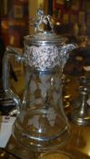 A silver plated floral glass claret jug with lion detail