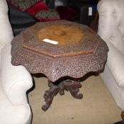 A C19th Burmese intricately carved centre top raised on carved animal tripod base