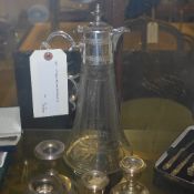 A cut glass and silver plated claret jug