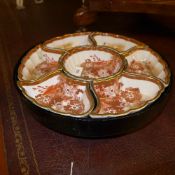 An ebonised and porcelain sectional lazysusan