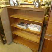A yewood open bookcase raised on bracket feet