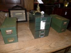 A collection of vintage metal filing drawers