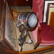 A chromium adjustable studio lamp with tripod base of diminutive form