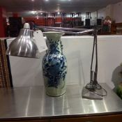 An industrial polished steel angle poise