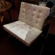 A Barcelona style chair upholstered in b
